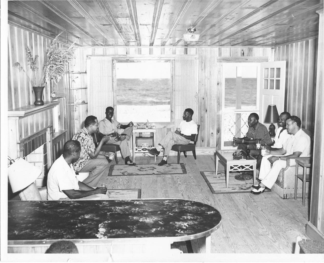 A group men lounging inside a beachside house in Ocean City. Photo courtesy of Ocean City Jazz Festival