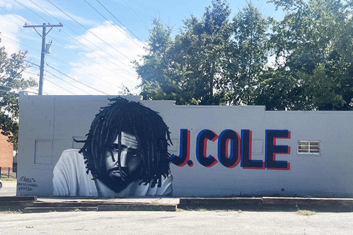 Mural of artist J Cole on the side of building