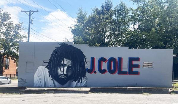 Mural of artist J Cole on the side of building