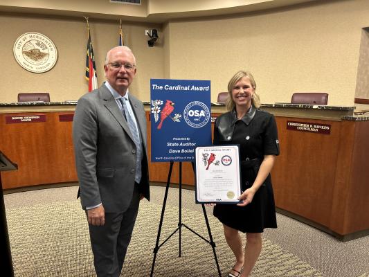 State Auditor Dave Boliek and Ms. Parris receiving Cardinal Award