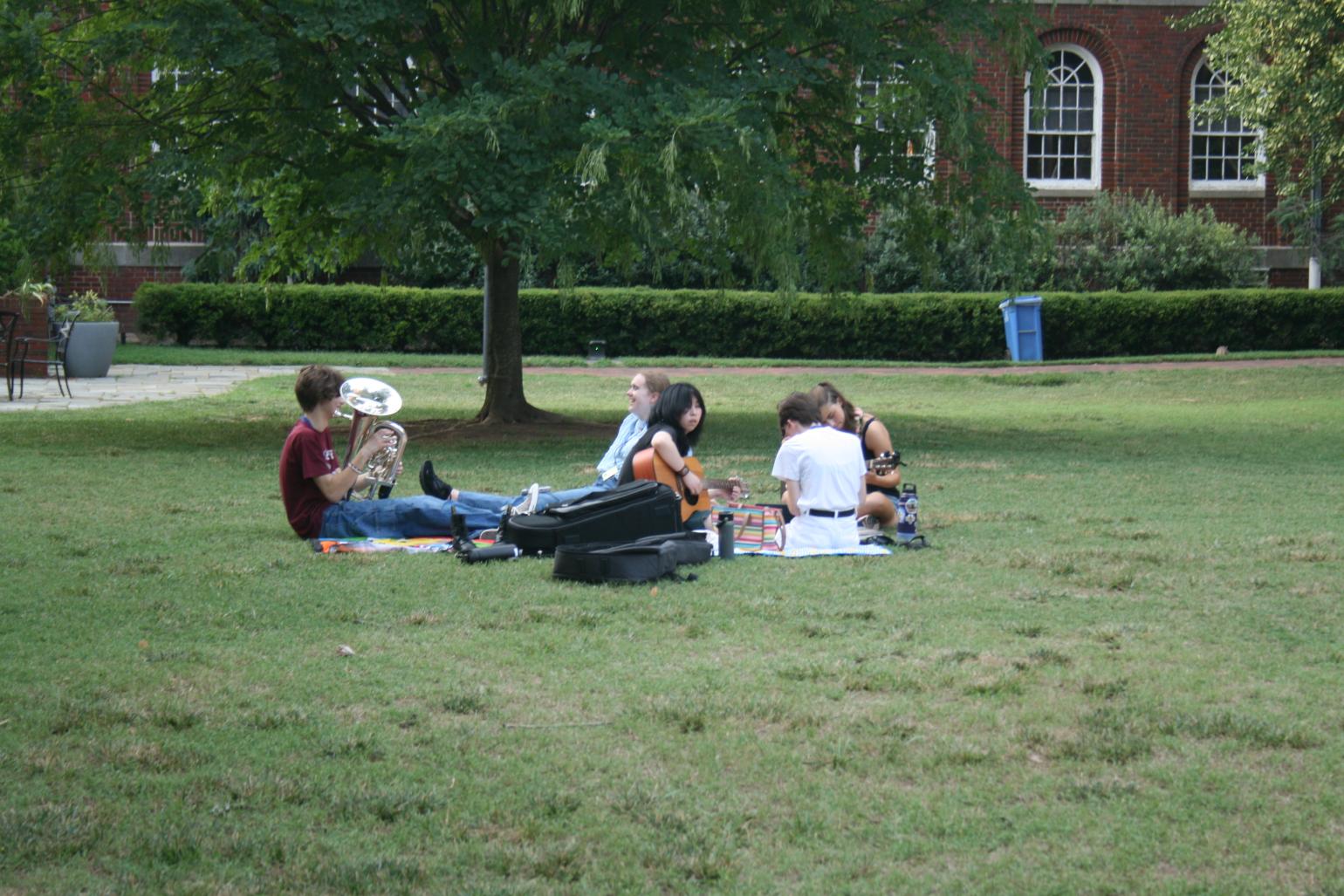 Students play instruments on the quad.