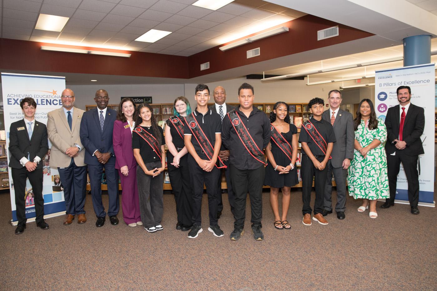 Superintendent Green stands with a group of students and school leaders at the launch event.