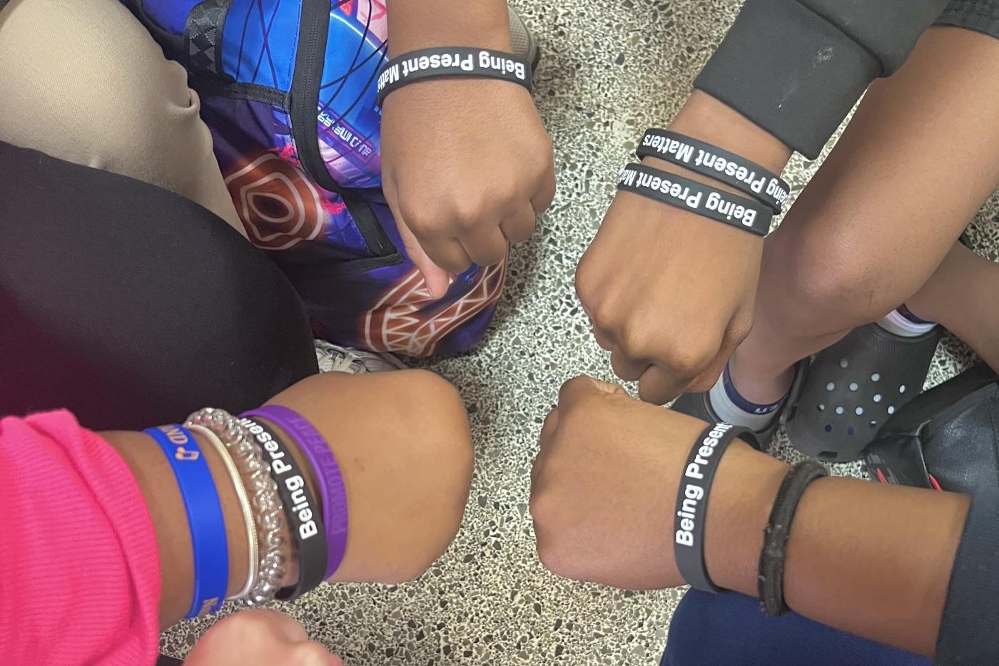 Student bracelets with the text "Being Present Matters"
