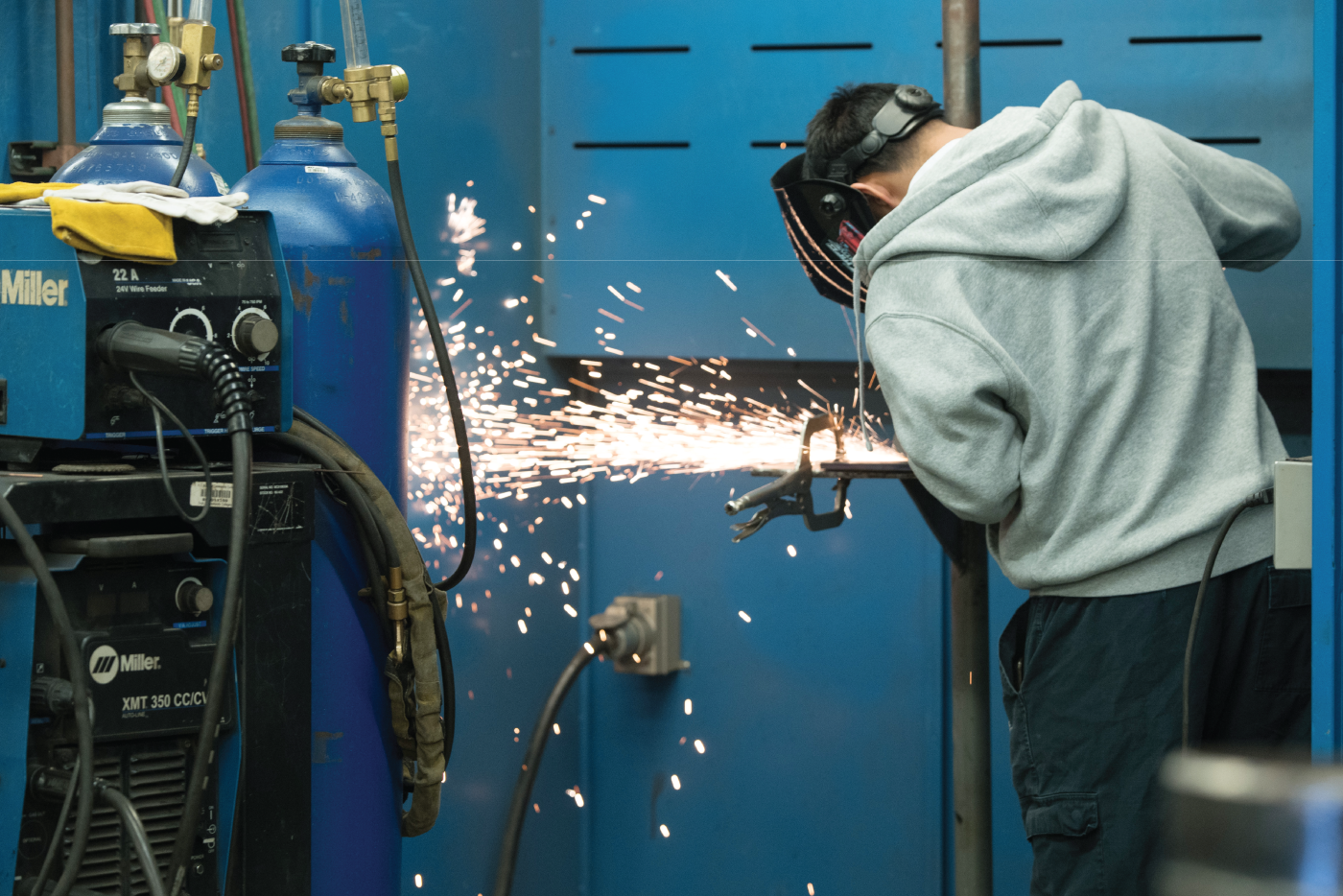 Sparks fly as a student uses welding equipment.