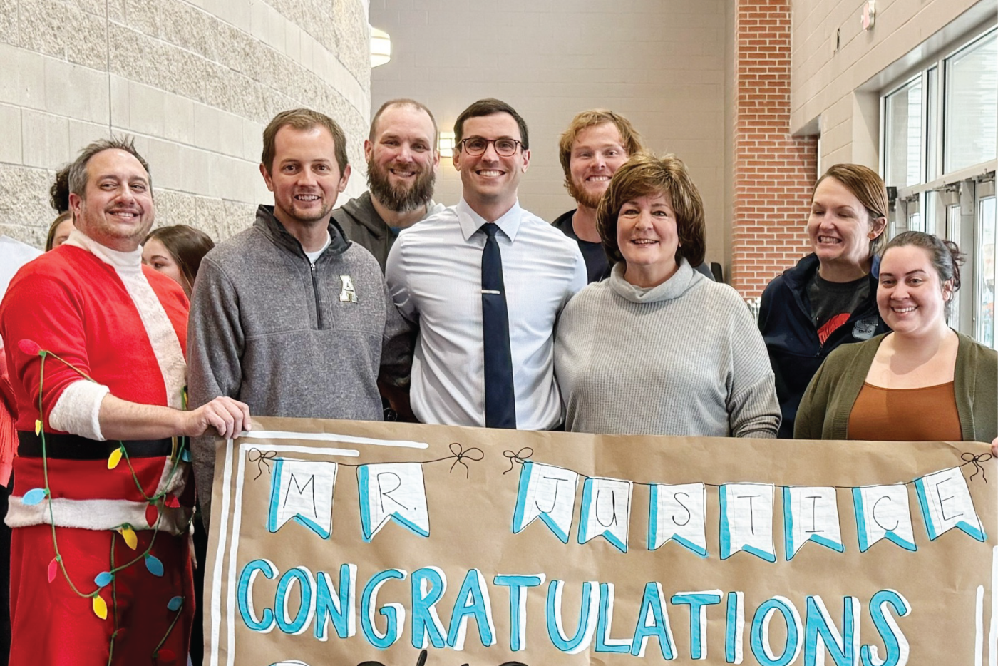 Alt text: Cason Justice is presented with the Southeast Region Teacher of the Year recognition.