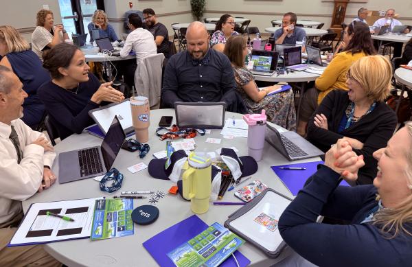 Attendees participating in a group discussion at their tables