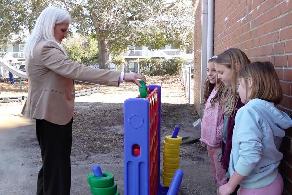 Principal at Morehead City Elementary School, Christy Propst, plays a giant game of Connect Four with students