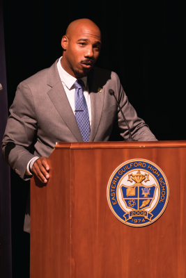 Headshot of Dr. Darrell Harris. Caption: Harris speaks during the evening event at Eastern Guilford High School.