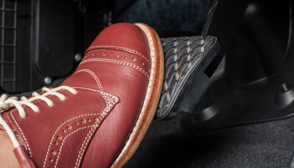 Foot using brake in an automobile