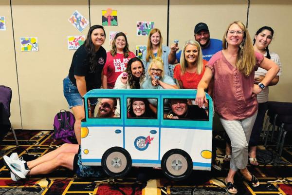 Principal Jessica Anthony, center in red, poses with staff members at Davenport A+ Elementary School.