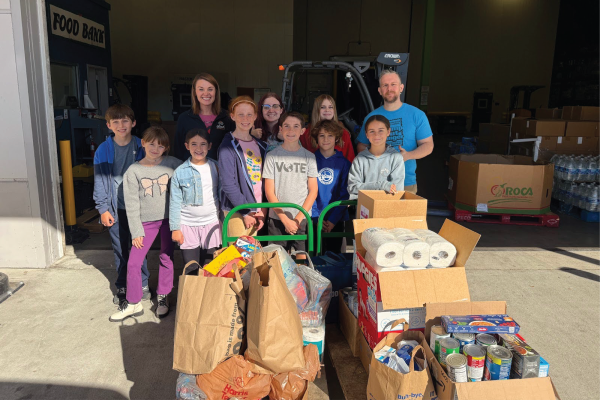 A class of Island Montessori students drop off donations they collected at a local food bank.