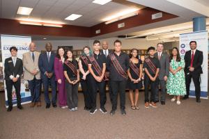 Superintendent Green stands with a group of students and school leaders at the launch event.