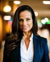 Picture of a woman with dark hair wearing a professional jacket and shirt