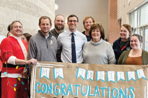 Alt text: Cason Justice is presented with the Southeast Region Teacher of the Year recognition.