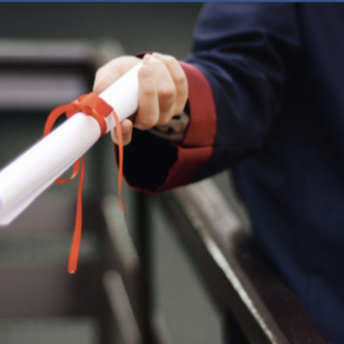 Hand receiving a diploma