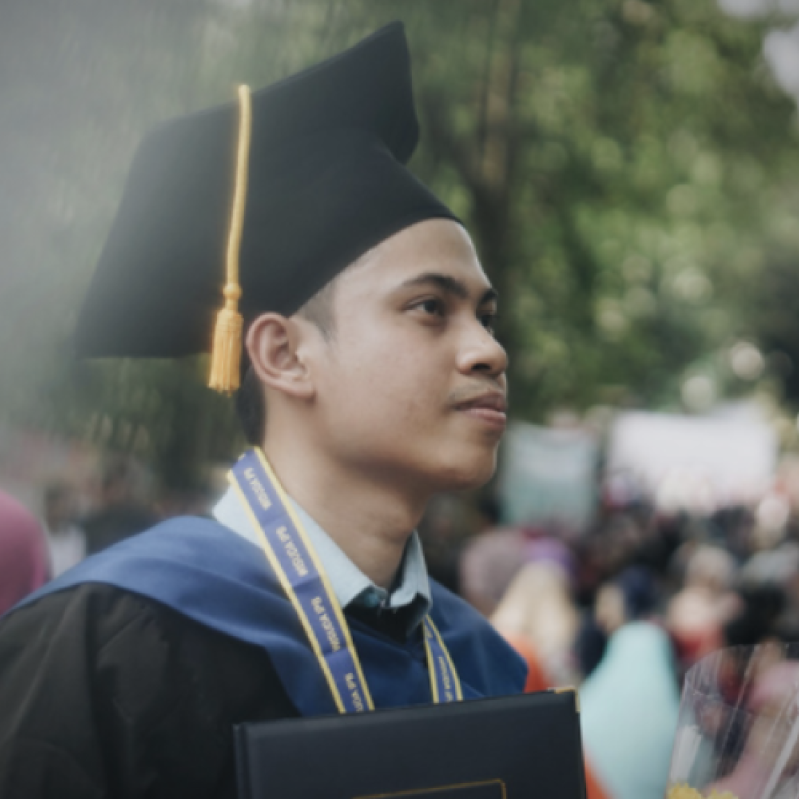 Student wearing graduation robes and cap