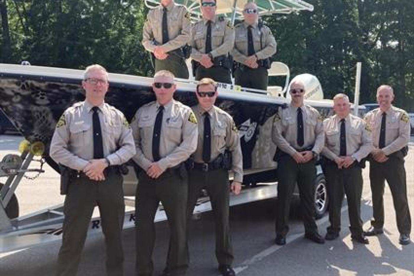 NC Wildlife Officers pose around a boat