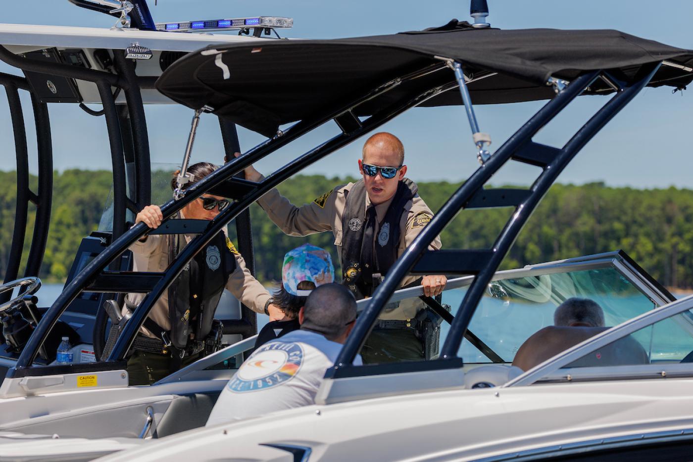 law enforcement officers in a boat on the water