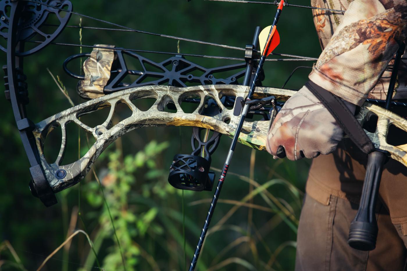 an archer's hand grips a bow
