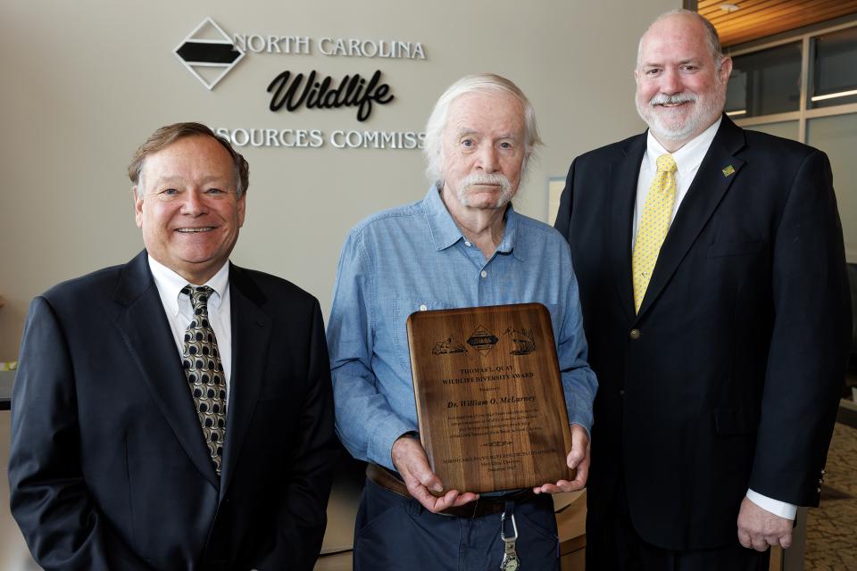 Quay Wildlife Diversity Award Winner Dr. Bill McClarney poses with his award next to agency staff