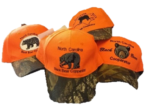 four orange ballcaps with camo bills with a bear graphic and the words North Carolina Black Bear Cooperator