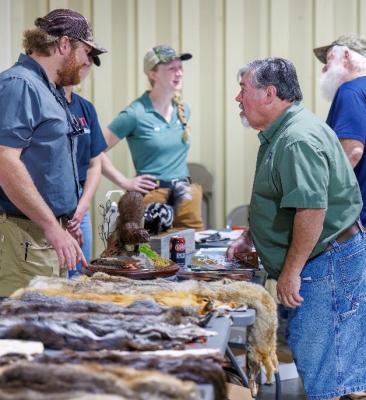 NCWRC wildlife biologists talk with trappers at a trappers convention