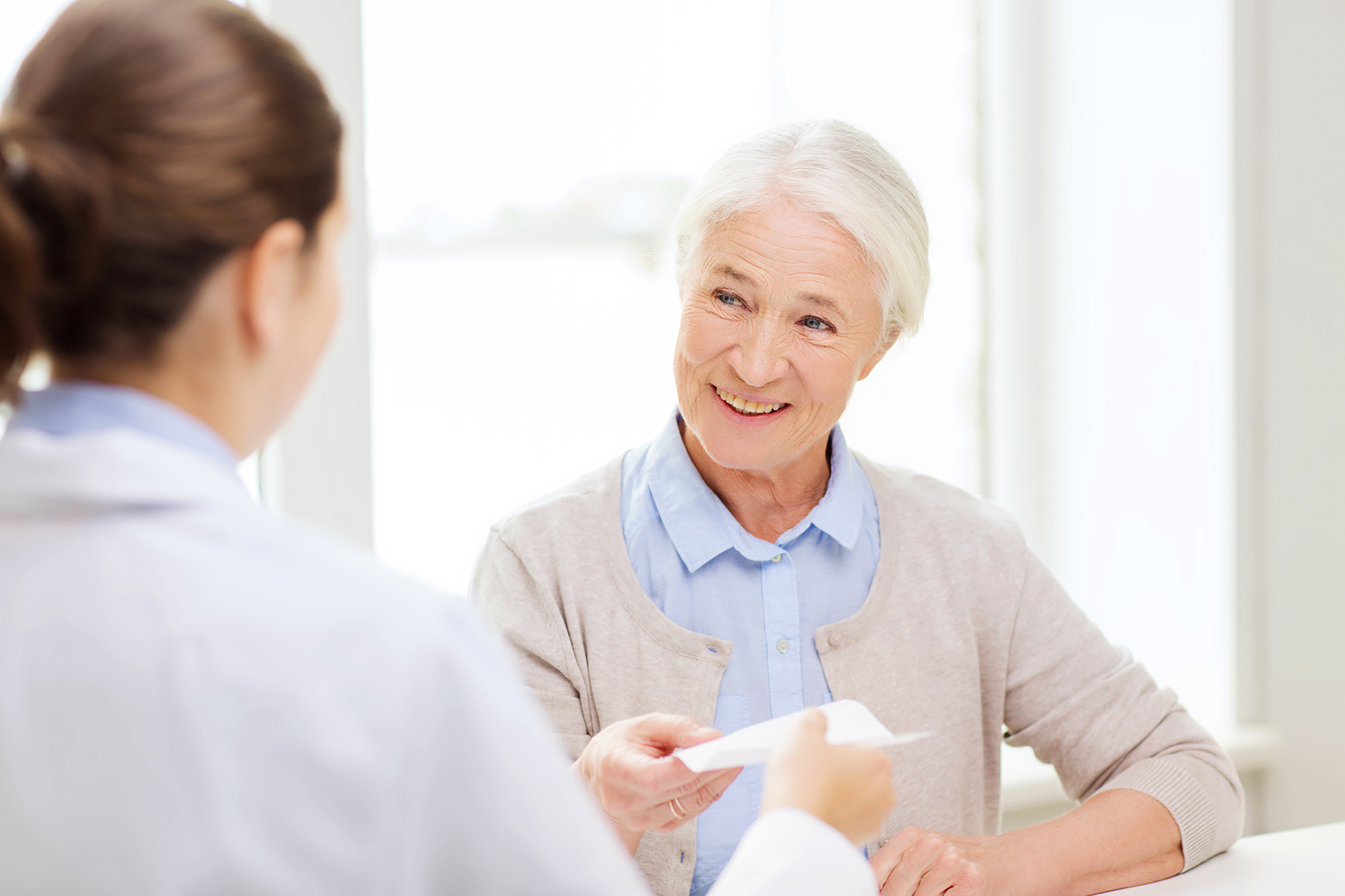 Senior woman speaking with doctor