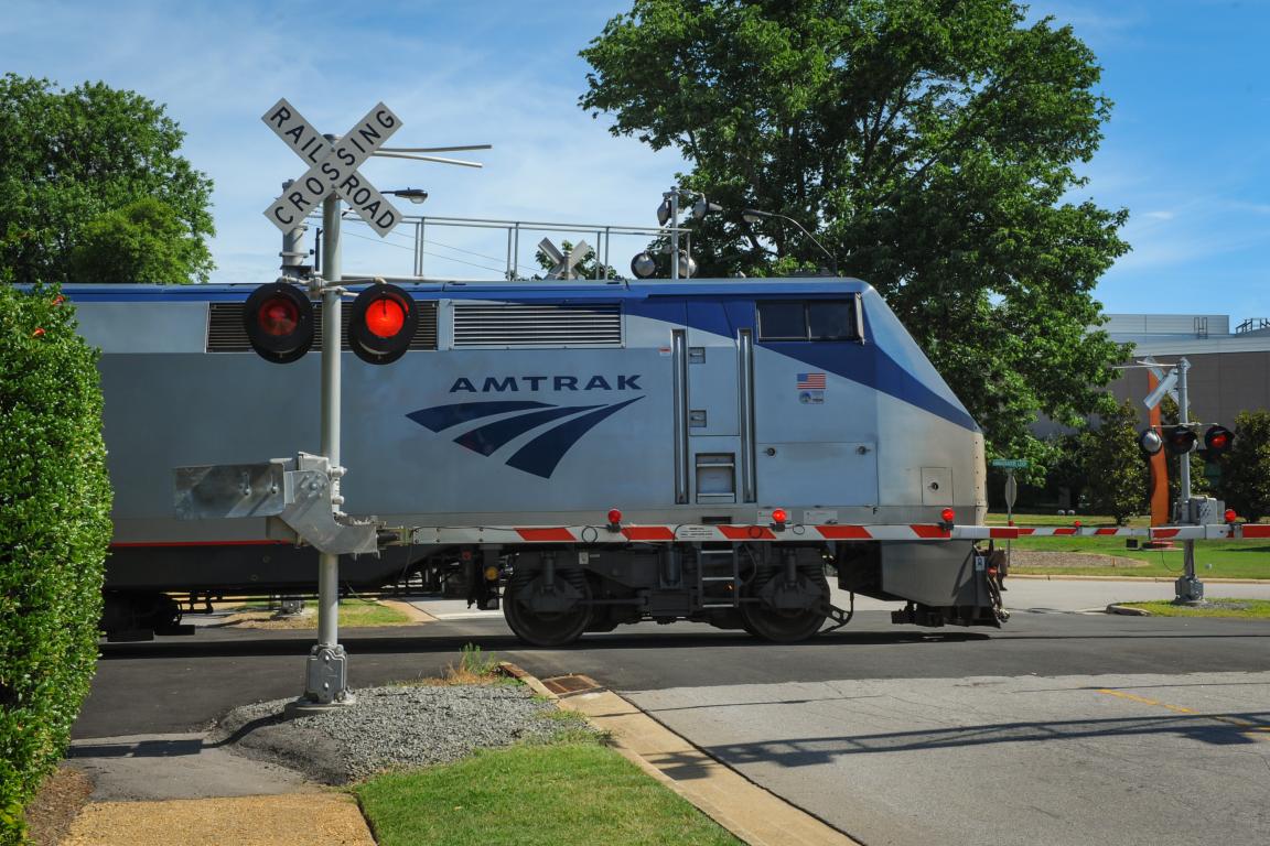 Amtrak train at the train track crossing signal