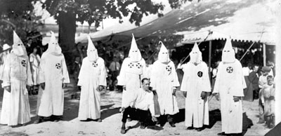 Klansmen in robes at tent meeting. Image taken from  the State Archives.