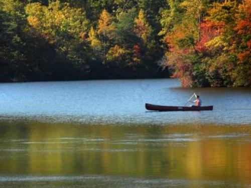 A canoe glides across a lake at Hanging Rock State Park