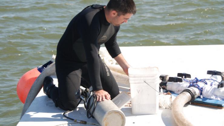 An archaeologist preps the drill used for in situ monitoring An archaeologist preps the drill used for in situ monitoring