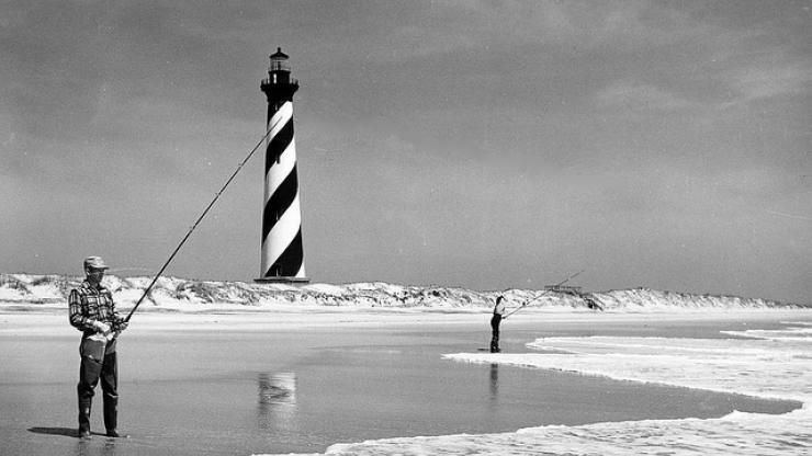Surf fishing in the shadow of the Cape Hatteras Lighthouse, circa 1956. Surf fishing in the shadow of the Cape Hatteras Lighthouse, circa 1956.
