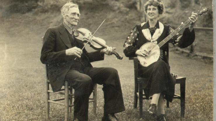 "Aunt Samantha" Bumgarner plays at the Asheville Mountain Music Festival, circa August 1938. "Aunt Samantha" Bumgarner plays a banjo with a man at the Asheville Mountain Music Festival, circa August 1938.