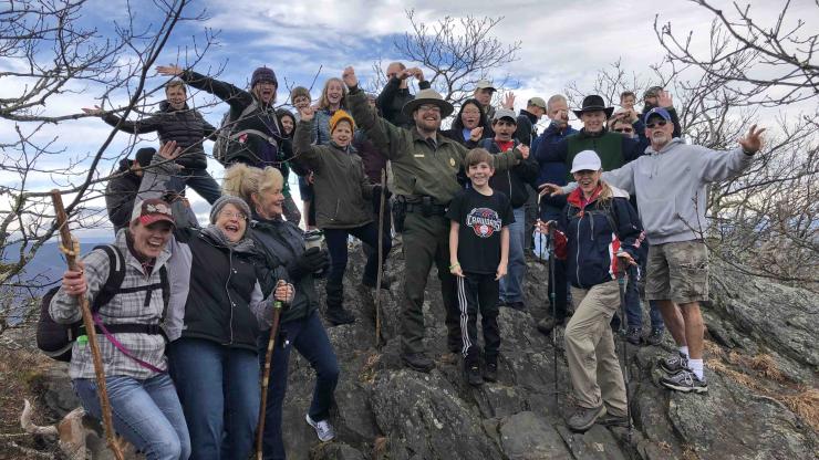 Hikers join Superintendent Joe Shimel on Luther Rock during a first day hike at Mount Jefferson State Natural Area