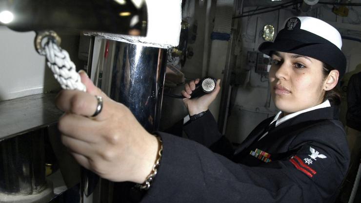 A quartermaster aboard the USS Kitty Hawk chimes the ship's bell A quartermaster aboard the USS Kitty Hawk chimes the ship's bell