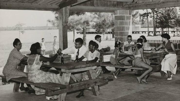 An African American family picnicking under a picnic shelter at Jones Lake State Park, circa 1950. An African American family picnicking under a picnic shelter, circa 1950.