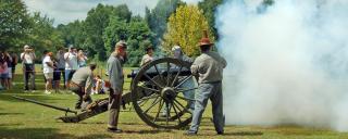 A crowd watches a cannon blast off at Bentonville Battlefield A crowd watches a cannon blast off at Bentonville Battlefield