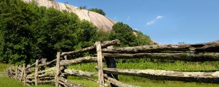Looking over a fence at the south face of Stone Mountain