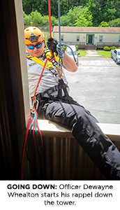 Officer Dewayne Whealton starts his rappel down the tower