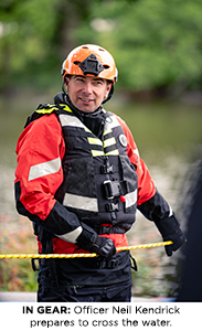 Officer Neil Kendrick prepares to cross the water