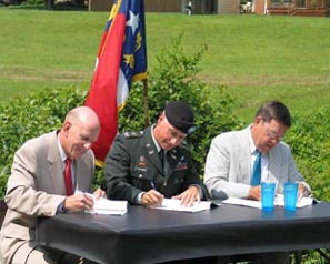 On July 22, 2003, (left to right) NCDENR Secretary Bill Ross, U.S. Army Corps of Engineers Col. Charles Alexander and NCDOT Secretary Lyndo Tippett sign the three-party Memorandum of Agreement that established the procedures of NCEEP.