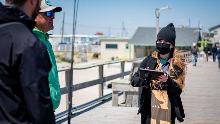 Recreational port agent interviewing fishermen Recreational port agent interviewing fishermen