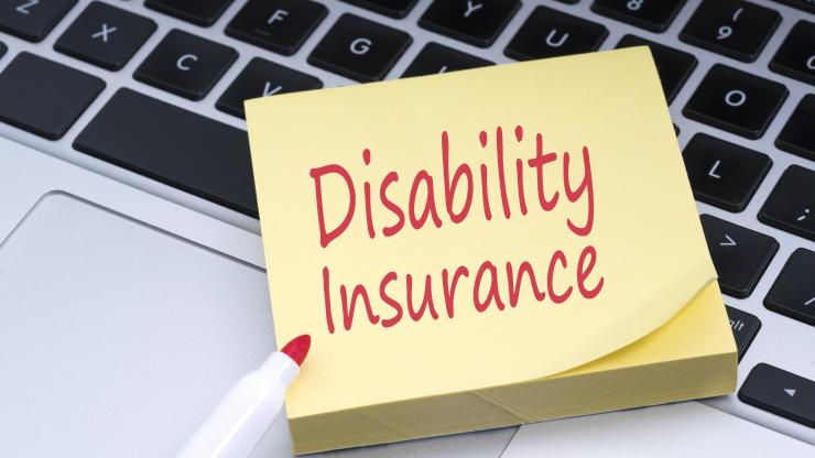 yellow sticky notepad with "Disability Insurance" written in red