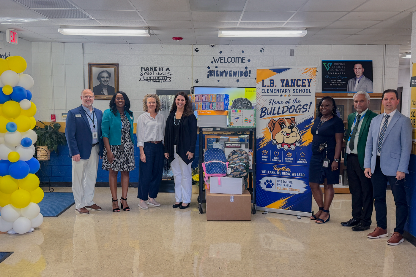 Group standing with school supplies