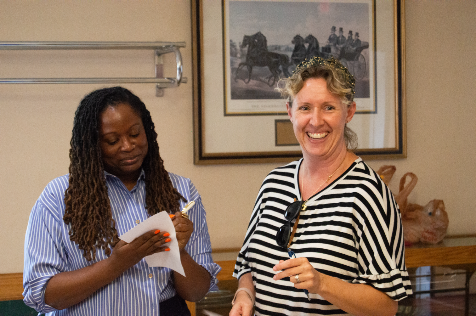 Dr. Maragaret Brunson signs a box on Kristen Dew's coworker bingo card.