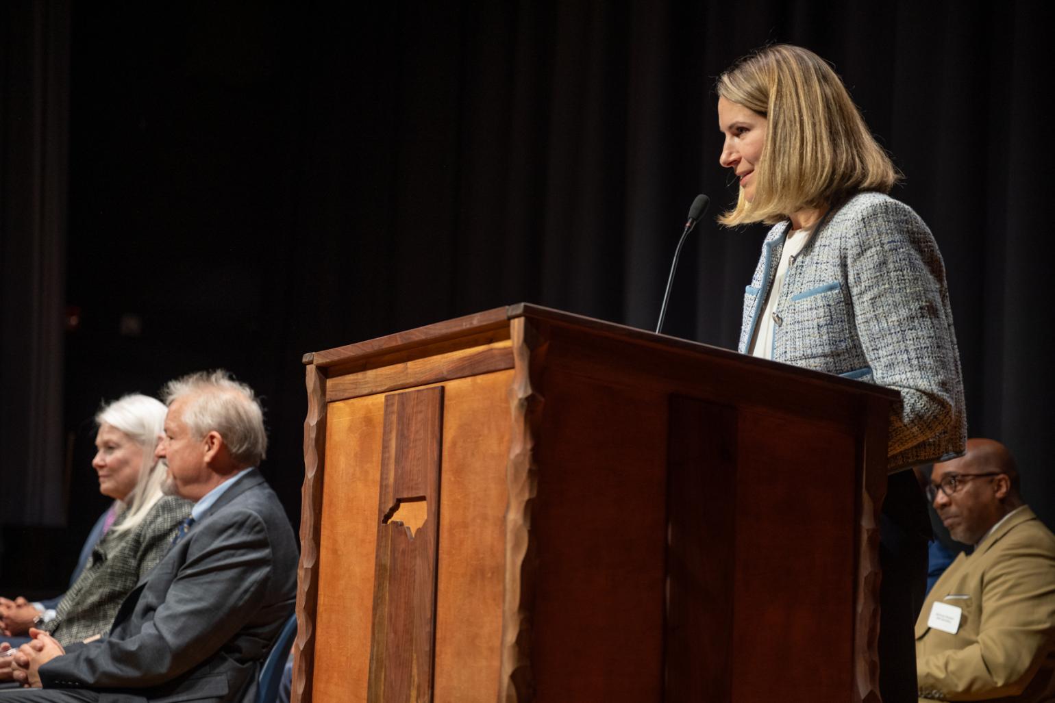 Woman speaking at a podium.