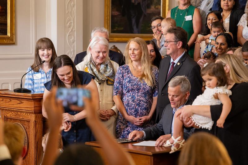 Governor Stein signs S1041 as OSHR Director Staci Meyer looks on.