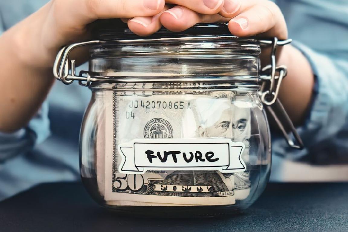 Hands on jar of money labeled "future."