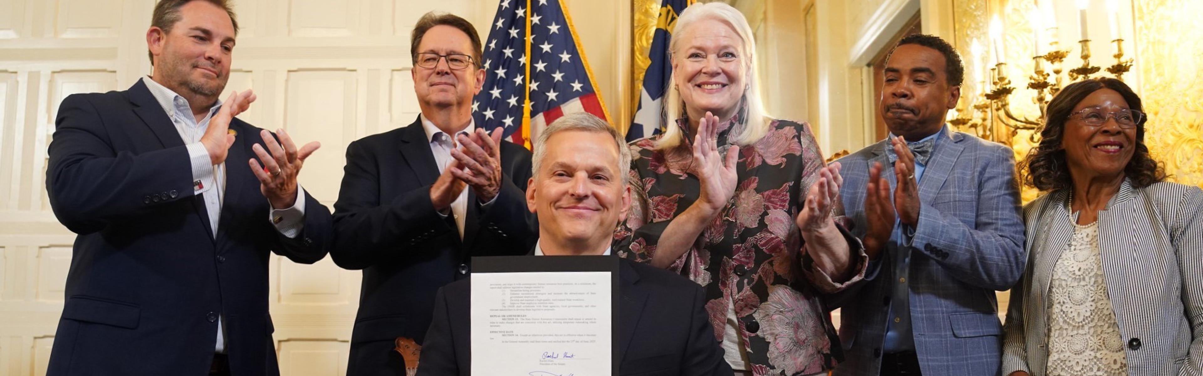 Governor Josh Stein signs SL 2025-34. OSHR Director Staci Meyer attends.