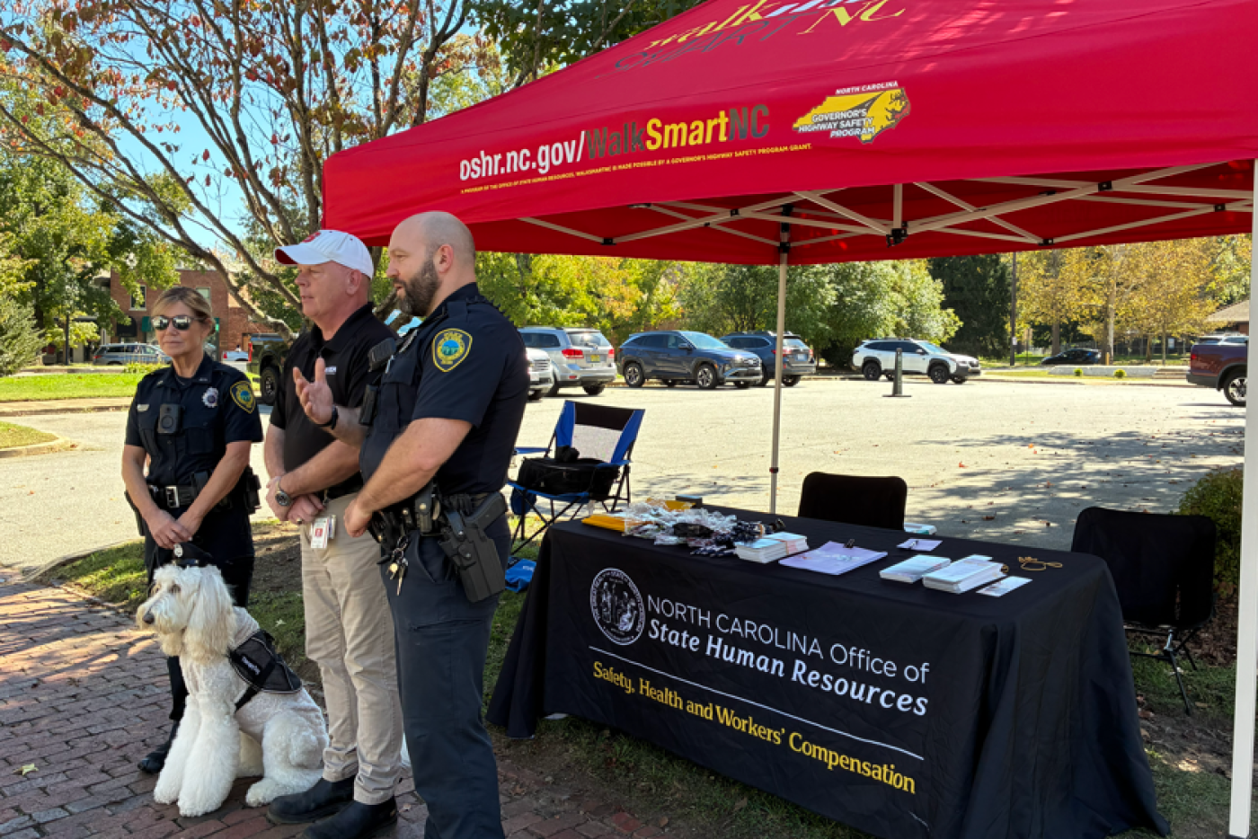 Asheville Police Department Officers gather for the event in front of the tent.